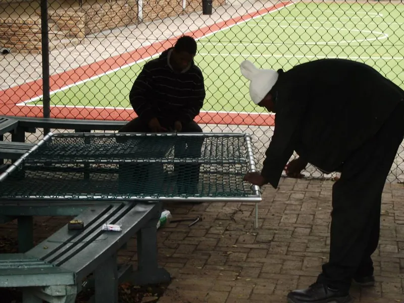 Mesh bench repair at sports facility courtside