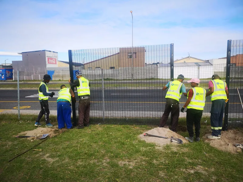 D&H Fencing team installing clearview fence posts in Cape Town