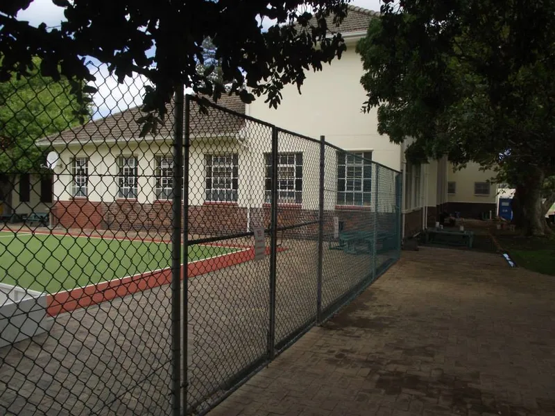 Diamond mesh fencing around school tennis court