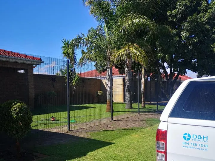 Residential clearview fence installation with landscaped garden in Cape Town