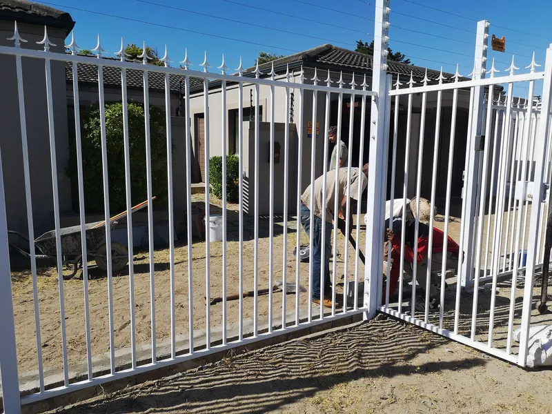 White palisade gate installation at Cape Town home